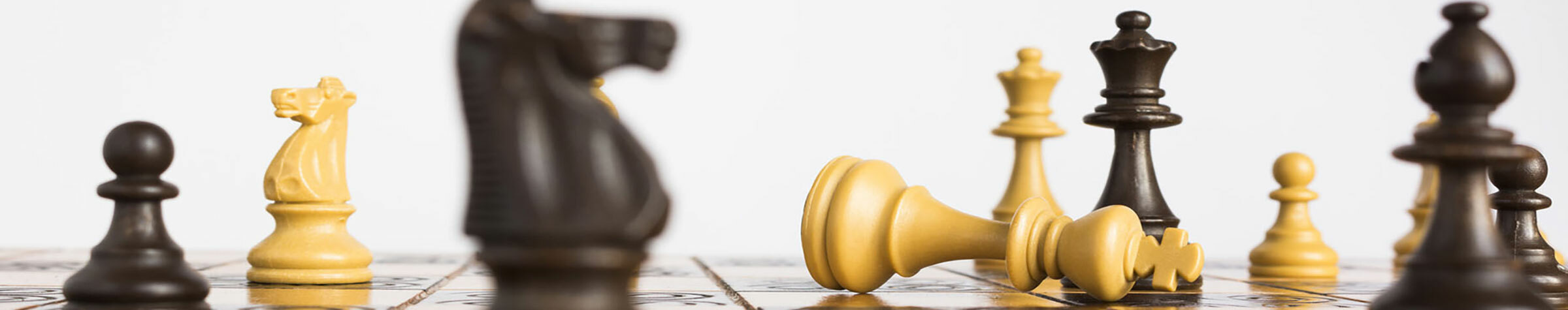 Black and white chess pieces on a chess board