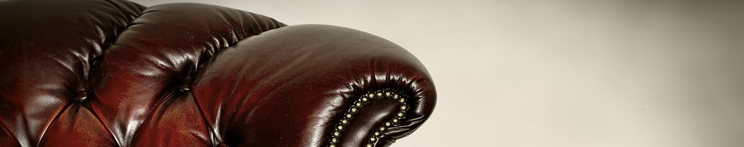 Dark brown leather chair against a white wall