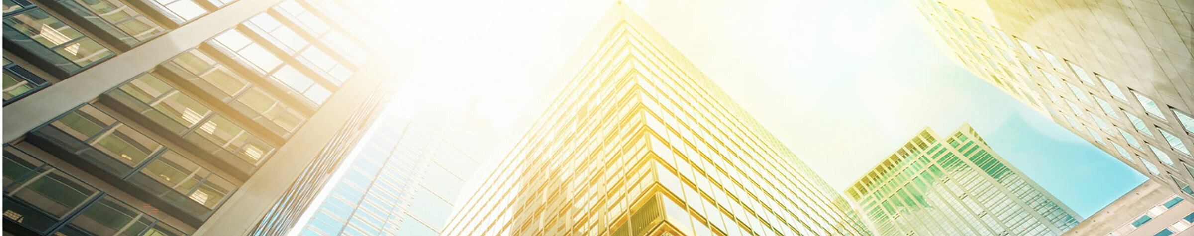 Glass skyscrapers with sunlight shining down