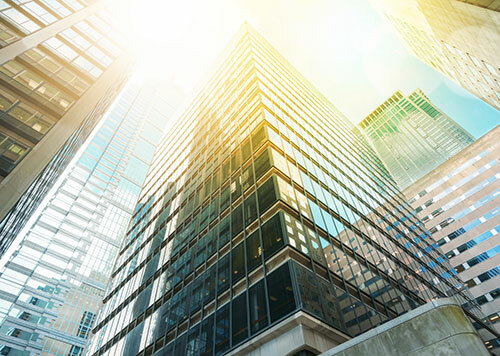 Looking up at tall glass buildings