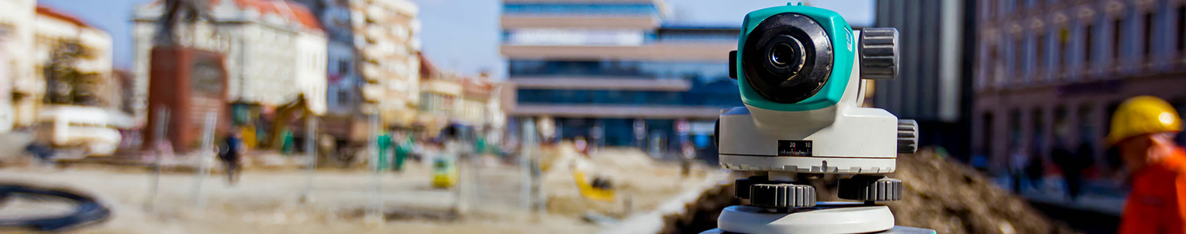 Gray, blue and black camera in front of an active construction zone