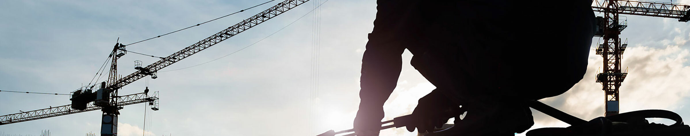 Man working with cranes in the background